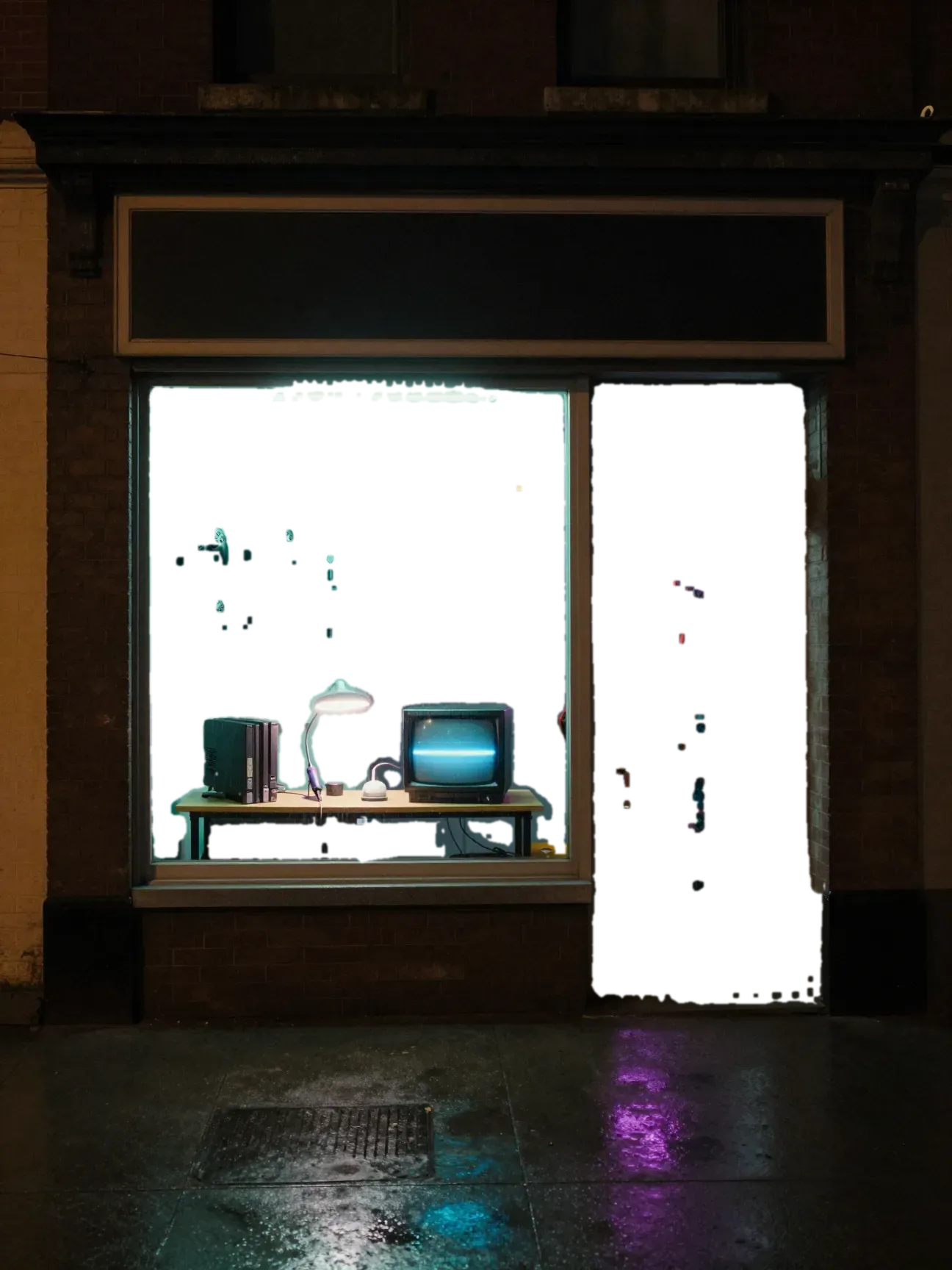 A narrow brick storefront at night glowing teal and violet. Game controllers hang on a pegboard, an opened console sits on a workbench beside a small old television, and an arcade cabinet stands inside the glass door.